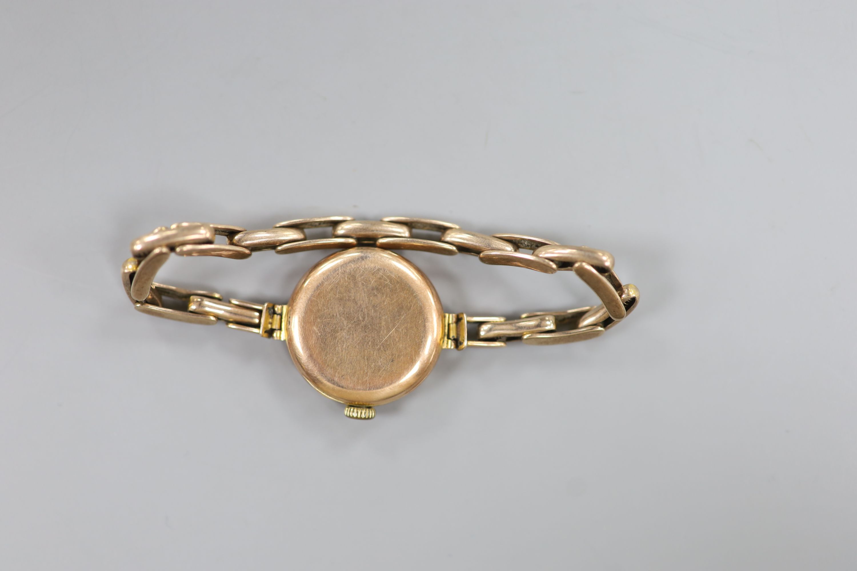 A lady's early 20th century 9ct gold Rolex manual wind wrist watch, on a 9ct flexible bracelet (no glass)